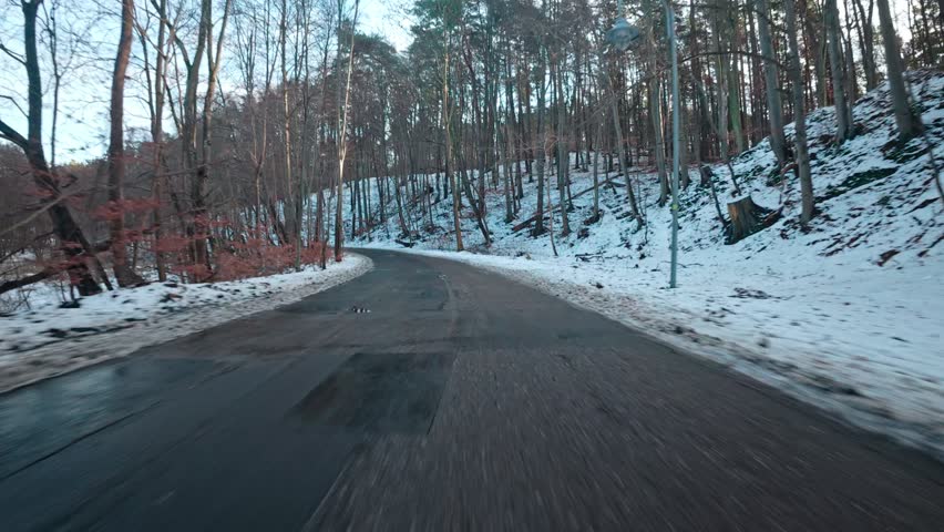 Car Driving Through Scenic Winter Forest Down Narrow Road Covered Fresh Snow