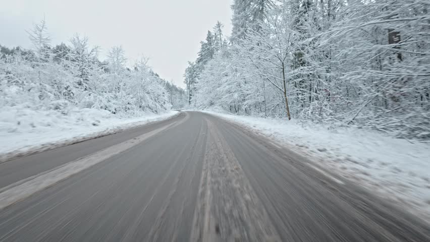 Car Driving Through Scenic Winter Forest Down Narrow Road Covered Fresh Snow