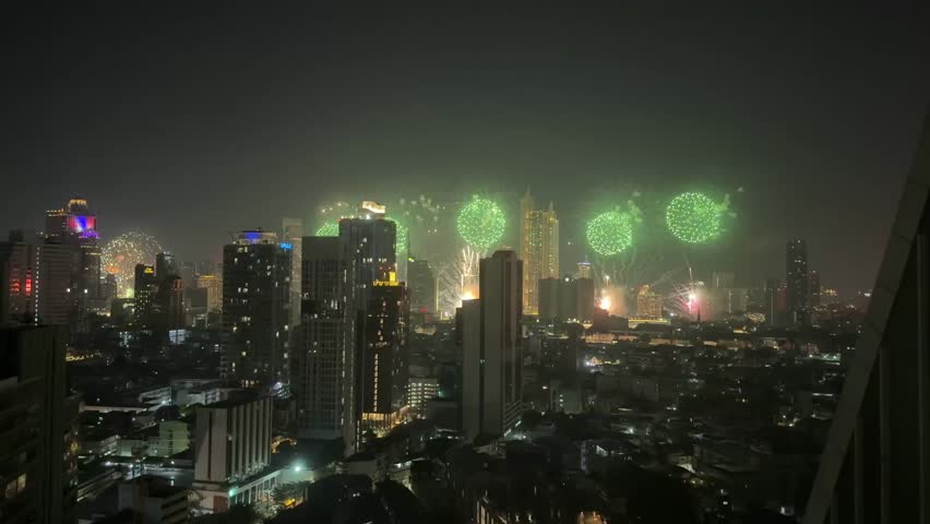New Year’s Eve 2026 fireworks over Bangkok at night. Bright bursts illuminate the skyline and city lights, capturing a festive countdown atmosphere and modern urban cityscape in Thailand.