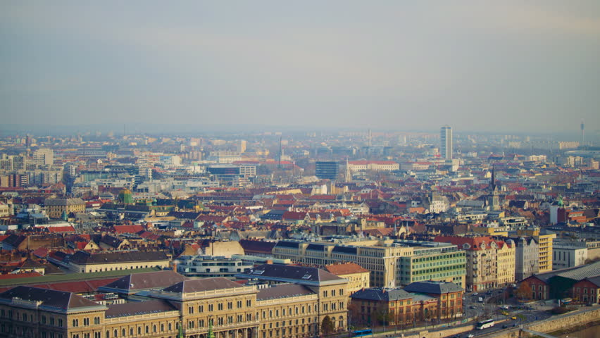 Dense view of Budapest buildings and rooftops forming a layered urban cityscape.