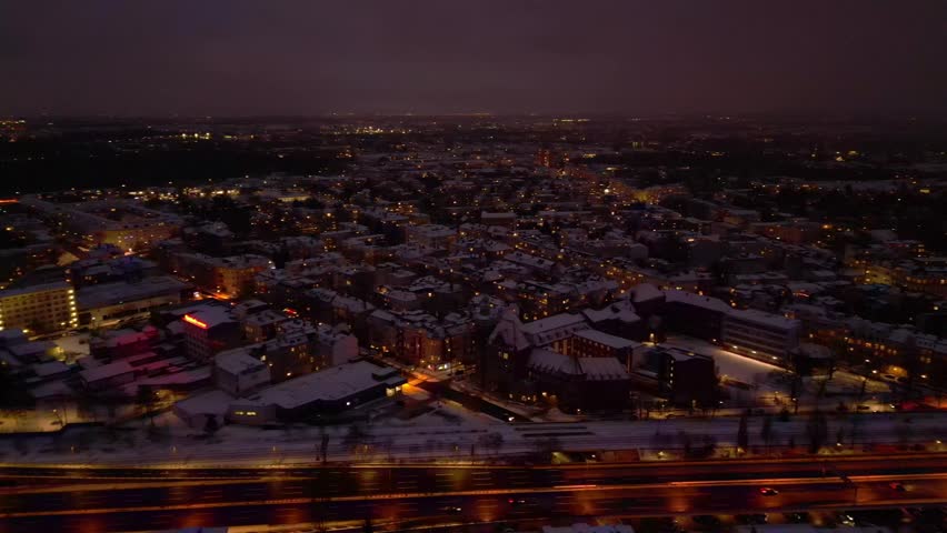 Berlin City rooftops covering in snow at dusk. Unique aerial view drone