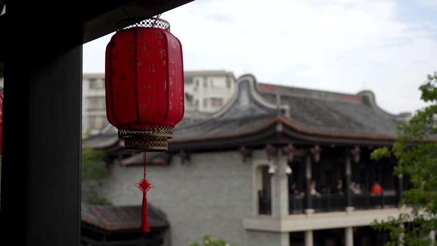 Traditional red Chinese lantern with historic architecture in the background in Yongqing Fang, a cultural district combining restored heritage buildings and modern urban spaces in Guangzhou.
