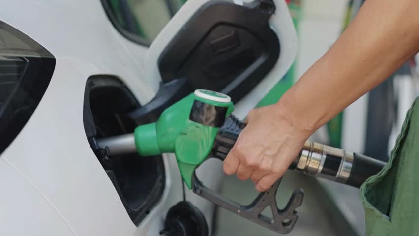 Man driver hand refilling the car with fuel at the gas petrol station Close up of a man refueling his car at a gas station Fuel gauge with warning to indicate low fuel level. Vector illustration of classic gas tank indicator on car dashboard panel. Gasoline speedometer on a black background 