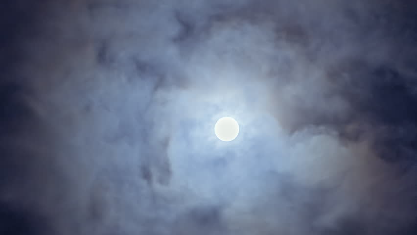 Full Moon with Moving Black Clouds. Nighttime Timelapse. Moon Hiding and Appearing Among Fast Moving Dark Clouds. Luminous Full Moon Gliding Behind Swiftly Moving Dark Clouds, Casting Shadows and