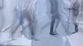 Team of surgeons wearing binoculars performing surgery against timelapse of people walking. Covid cells floating over woman wearing face mask using smartphone. - Powered by Shutterstock - Get 15% off with code: PIKWIZARD15