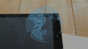Animation of spinning globe over close up of office equipment on wooden table. Global networking and business technology concept - Powered by Shutterstock - Get 15% off with code: PIKWIZARD15