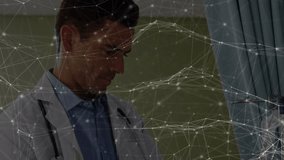 Animation of network of connections over caucasian male doctor and senior patient. Health, medicine, connections and technology concept digitally generated video. - Powered by Shutterstock - Get 15% off with code: PIKWIZARD15