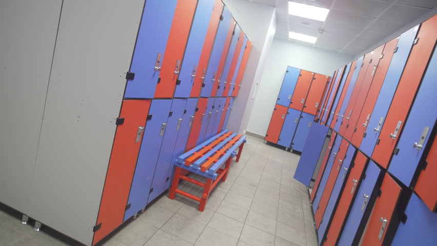 Benches aligned with locker colors enhance usability and visual harmony in pool changing area. Space appears organized ergonomic friendly