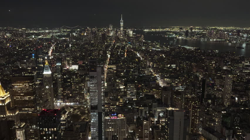 New York City skyline illuminated at night wide shot