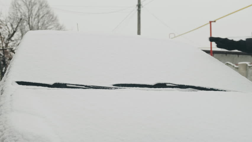 Frosted Glass Cleared By Man In Winter, Early Morning Frost Requires Manual Effort To Clear Windshield For Driving