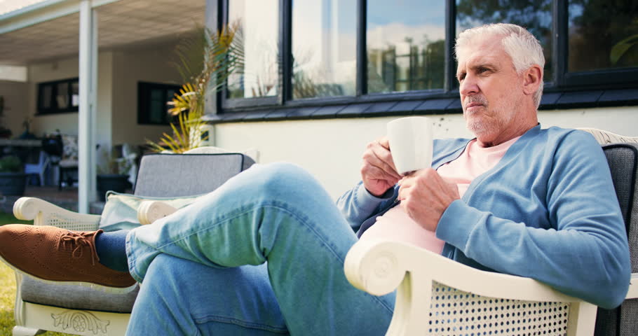 Thinking, coffee and senior man in backyard, relax and retirement with afternoon break. Outdoor, house and mature person with ideas, memory and herbal tea with moment, pensioner and nursing facility