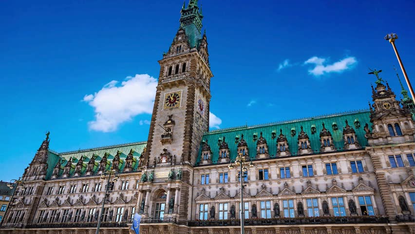 Panorama showing a building of the Hamburg City Hall timelapse, the seat of the government of Hamburg, located in the Altstadt quarter in the city center. View from the main square under a cloudy skyHamburg City Hall or Hamburger Rathaus is the seat of local government of Hamburg, Germanyalster, architecture, attraction, building, central, ,  hall, destination, downtown, economy, europe, european, famous, german, germany, government, governmental, hall, hamburg, hanse, hanseatic, historic, historical, history, house, kleine, landmark, neo renaissance, old, panorama, parliament, place, port, rathaus, seat, senate, sightseeing, sky, square, station, summer, tourism, tourist, tower, town, travel, urban, 