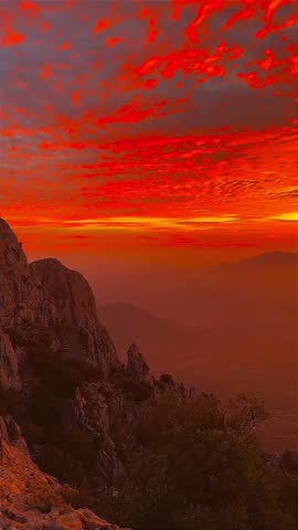 Dramatic Red Sky at Sunrise Over Mountain Silhouette
