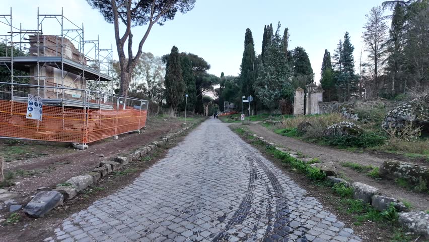 Appia Antica in Rome. Walking on the ancient Appian Way in Rome, tourist walk to discover the ruins of ancient Rome. Tourism in Italy, Grand Tour in an archaeological park