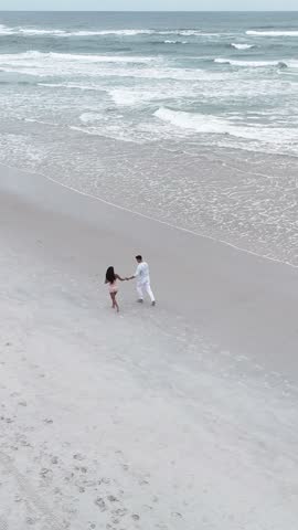 Romantic couple walking together on a secluded beach
