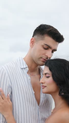 Romantic young couple embracing and kissing on the forehead