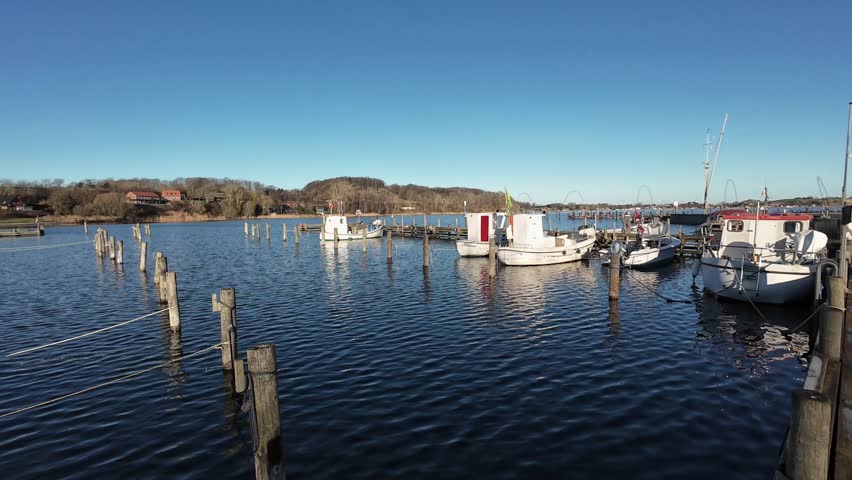 Small Winter Harbor in Southern Denmark with Hills and Traditional Fishing Boats Aerial View