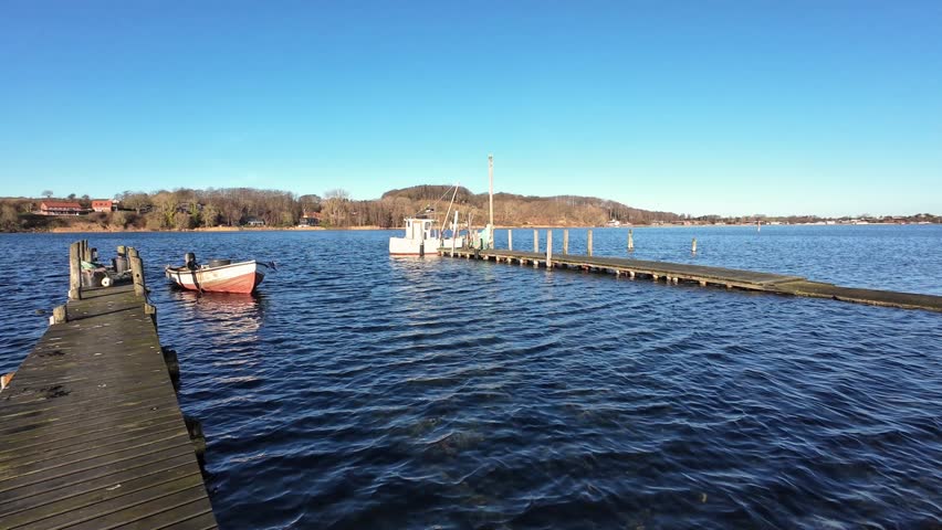 Small Winter Harbor in Southern Denmark with Hills and Traditional Fishing Boats Aerial View