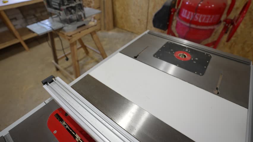 Stationary circular saw with a serrated metal blade. Combined table.