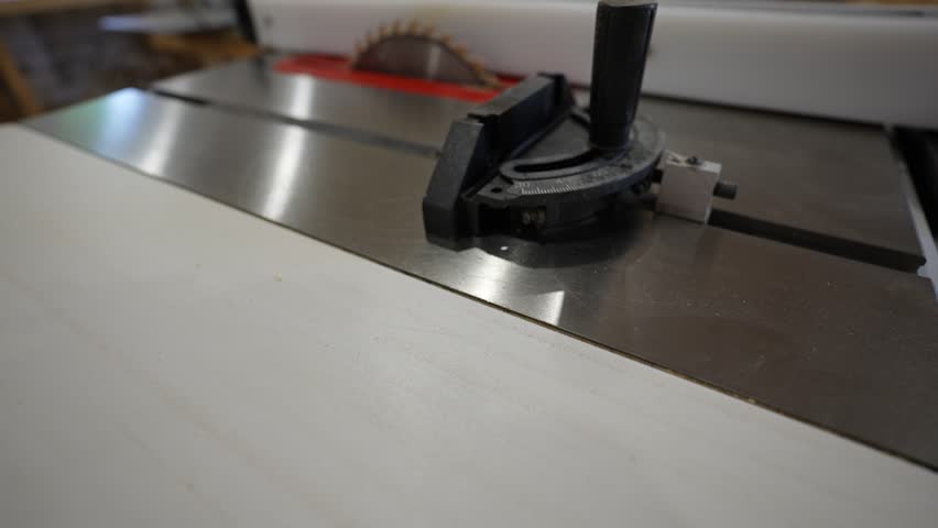 Stationary circular saw with a serrated metal blade. Combined table.