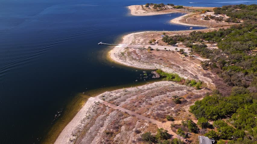 High aerial flyover of Bob Wentz Park on Lake Travis on a sunny autumn day, Austin, Texas