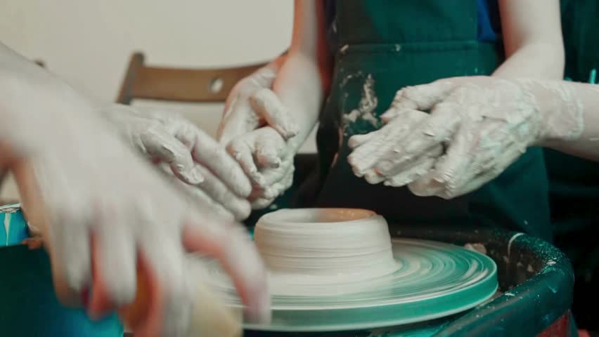 Hands Crafting Clay Pot on Pottery Wheel