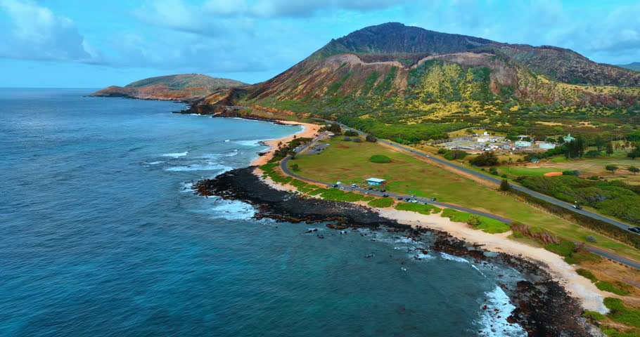 Footage along the shore of Oahu, Hawaii, USA. Approaching the Diamond Head Crater under the overcast sky.