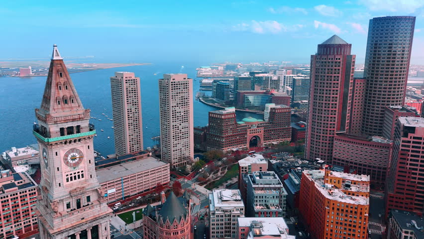 Top of the Custom House, Harbor Towers and International Place Complex in the financial center of Boston, Massachusetts, USA. The Charles River waterscape with sailboats on at backdrop.