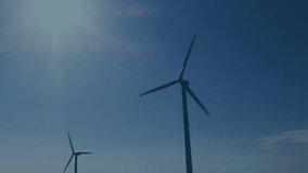 Animation of statistical and stock market data processing over spinning windmill against blue sky. Global economy and renewable energy technology concept - Powered by Shutterstock - Get 15% off with code: PIKWIZARD15