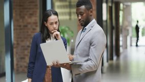 Colleagues talking over laptop analyzing ecommerce security with animated cart and lock network. Collaboration, innovation, technology, communication, office, digital, teamwork - Powered by Shutterstock - Get 15% off with code: PIKWIZARD15