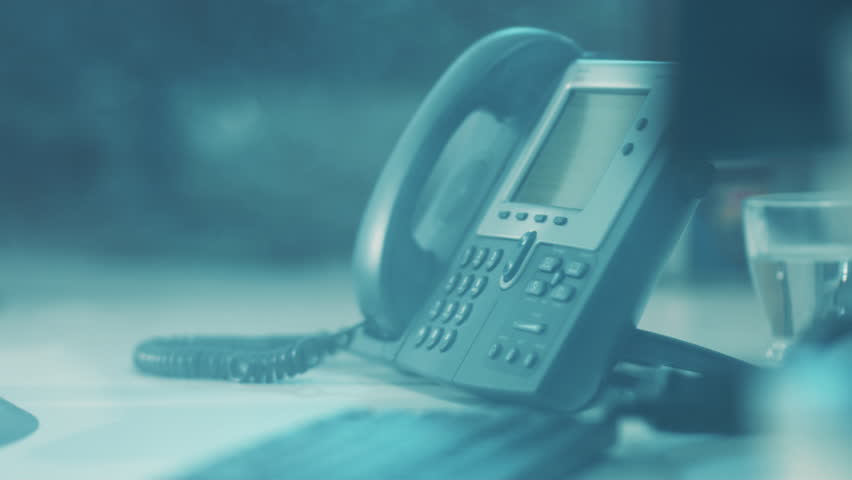 Quiet reception area with vintage phone setup, Still image capturing deserted office with subdued blue tones