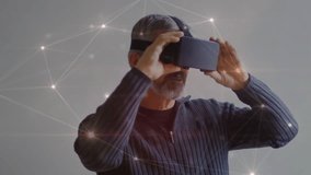 Animation of network of connections over caucasian man using vr headset. global business and digital interface concept digitally generated video. - Powered by Shutterstock - Get 15% off with code: PIKWIZARD15