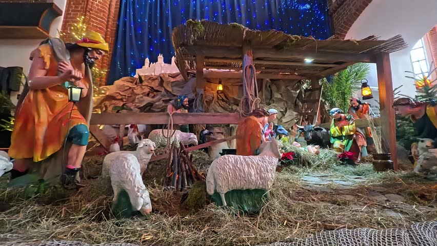A festive nativity display featuring Mary and Joseph with baby Jesus, surrounded by animals in a rustic stable. Warm lighting and hay create a cozy Christmas scene celebrating faith and family.
