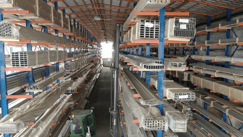 Drone Tracking Forklift Inside Aluminum Warehouse