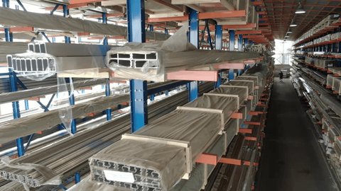 Drone Lowering Diagonally Inside Metal Warehouse