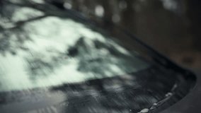 Automotive front windshield wipers on a vehicle swiftly move, clearing dirt and grime, thereby providing an unobstructed view through the glass surface, ensuring a safe drive with optimal visibility - Powered by Shutterstock - Get 15% off with code: PIKWIZARD15