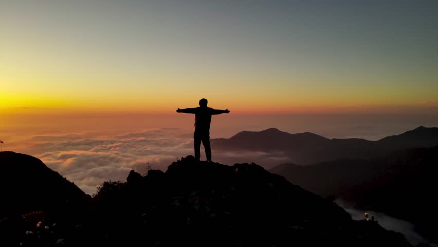 Breathtaking sunset from a mountain top with vibrant sky colors, clouds, and panoramic views, capturing nature’s serene beauty.