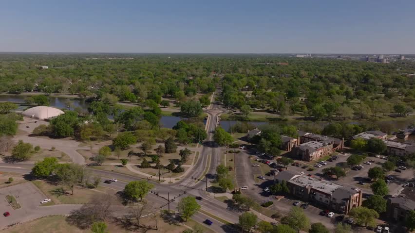 Bird’s-eye view of Wichita, USA, showcasing streets, homes, and vibrant green scenery, highlighting the city’s blend of urban life and natural charm.