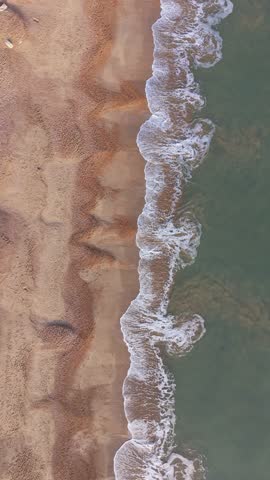 Vertical top down view of a famous beach in Weymouth UK on a winter sunny day