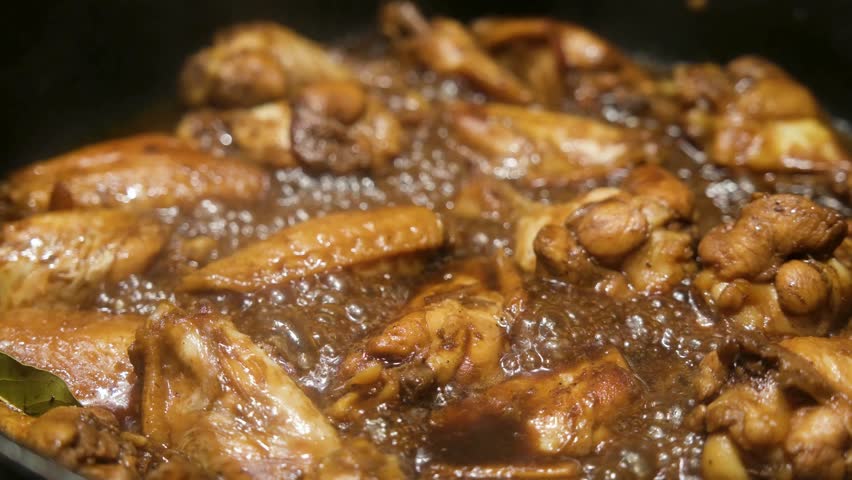 Delicious Filipino Traditional Dish Chicken Adobo is being cooked in a large pot for a gathering. Chicken Adobo is a dish easily cooked by Filipinos as it is only soy and vinegar based