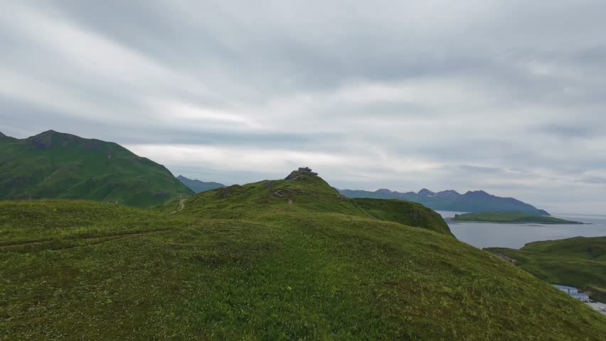 An aerial view of American military bunker from World War II used in battles against the Japanese on Unalaska island, Alaska. Drone flight over the mountain ridge of Dutch Harbor. 