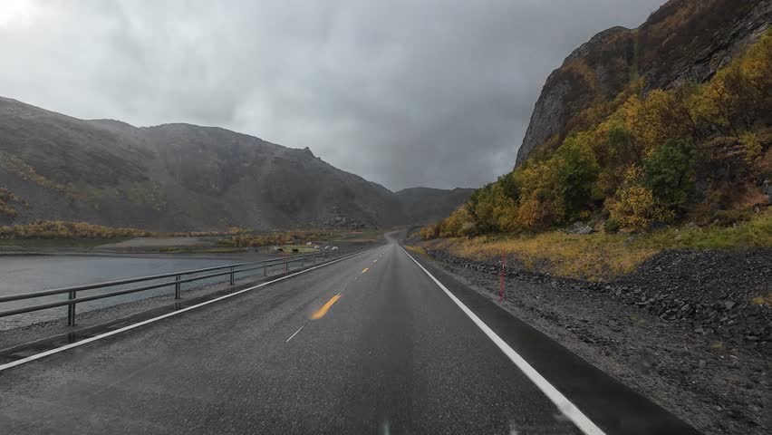 POV from a camper driving along a winding mountain road towards the Nordkapp in autumn