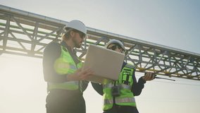 Industrial Engineers Inspecting Construction Site with Laptop, engineering teamwork, Industrial inspection, project management and modern construction technology, Oil and Gas Petrochemical industry. - Powered by Shutterstock - Get 15% off with code: PIKWIZARD15