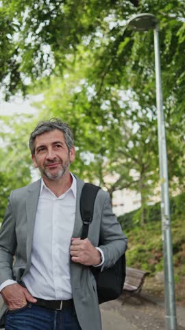 Businessman walking in the park - slow motion montage