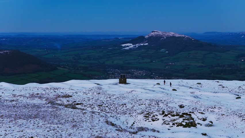 4K Aerial View of Abergavenny in the distance ontop of mountain Known as Blorenge South Wales UK Drone footage Snow on mountains
