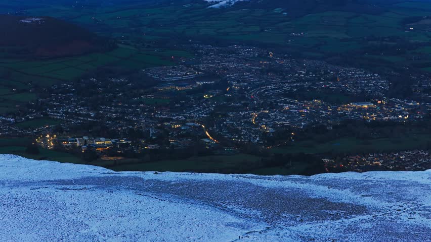4K Aerial View of Abergavenny in the distance ontop of mountain Known as Blorenge South Wales UK Drone footage Snow on mountains