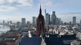 Aerial drone footage of Frankfurt Cathedral showing a detailed view of the clock tower with visible motion of the clock hands. Captured on a clear, sunny winter day at midday, emphasizing time passage and subtle movement in historic European architecture. - Powered by Shutterstock - Get 15% off with code: PIKWIZARD15