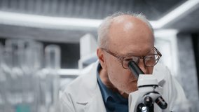 Researcher teaching intern how to analyze genetic samples with high tech microscopic equipment in laboratory. Elderly scientist mentoring young woman to use examine tissue in research clinic, camera B - Powered by Shutterstock - Get 15% off with code: PIKWIZARD15