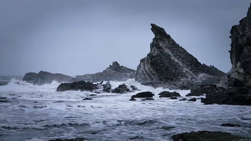 Powerful King Tide Waves Crashing Against Triangle-Shaped Cliff on Rugged Ocean Coast at Shore Acres State Park.	 