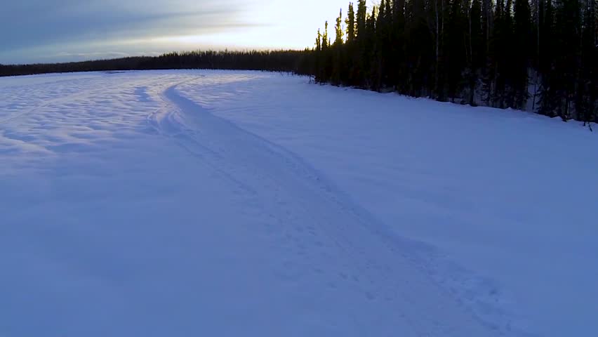 Wide shot of frozen lake at sunset in Alaska